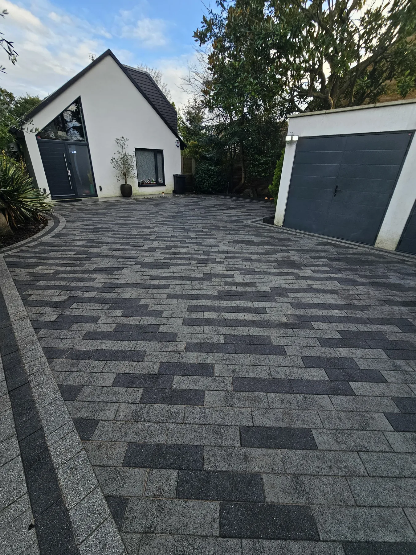 Charcoal block paving driveway at a modern house