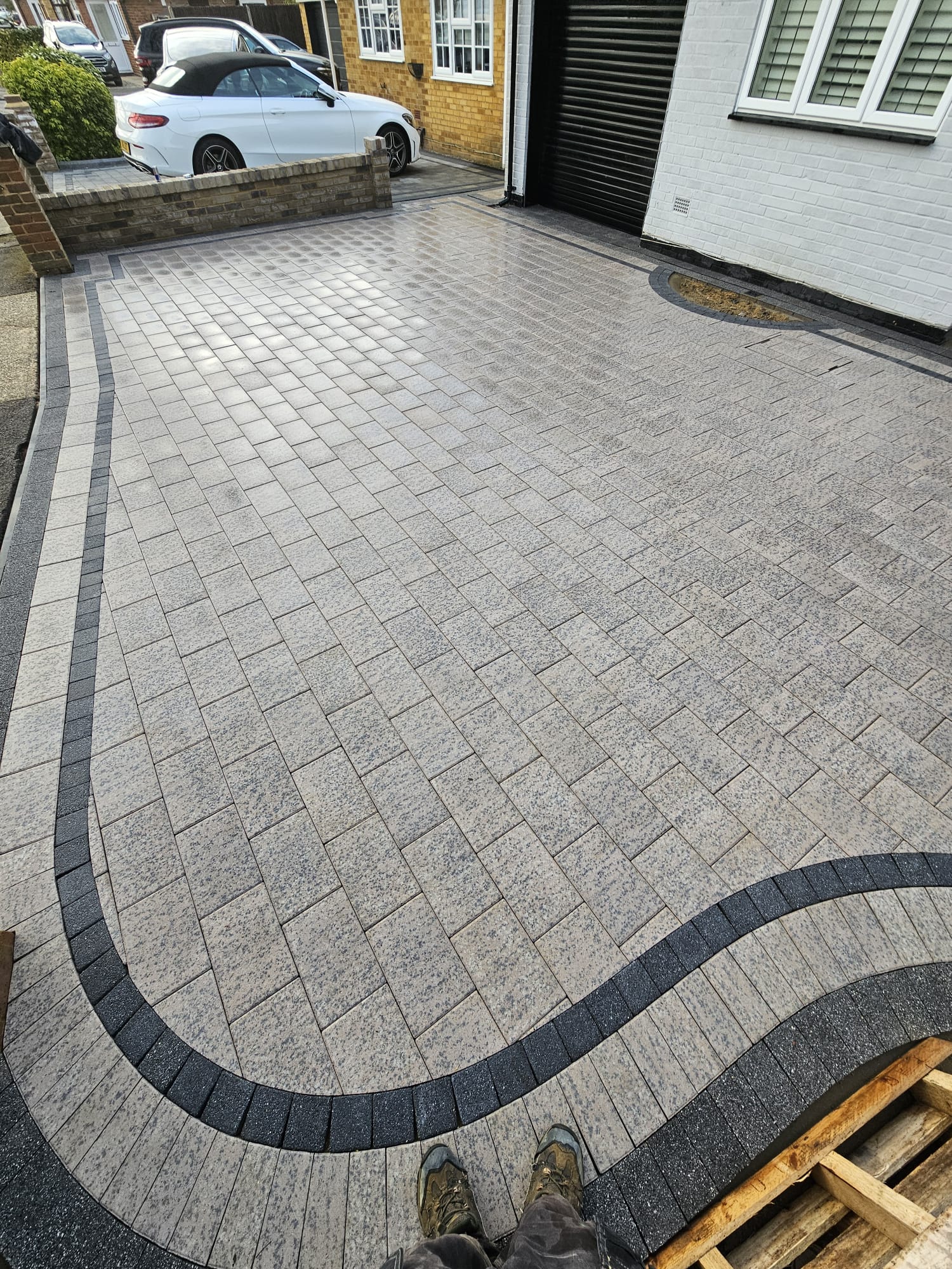 Block-paved driveway with curved contrast border in West London