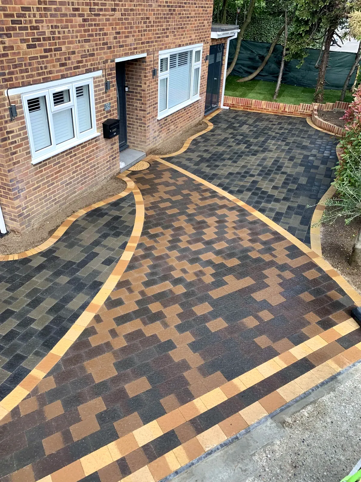 Multi-tone block paving driveway with orange curved border
