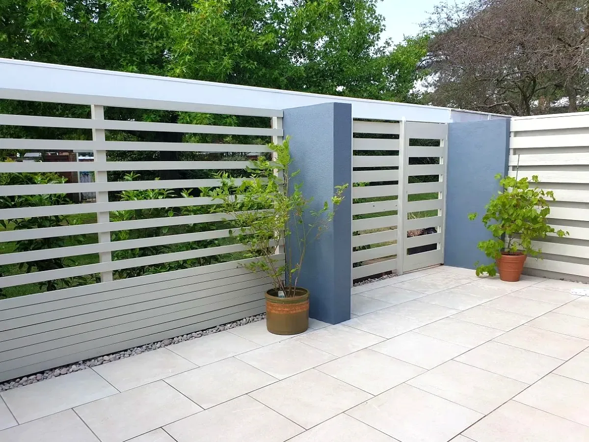 Light grey slatted fence with porcelain patio