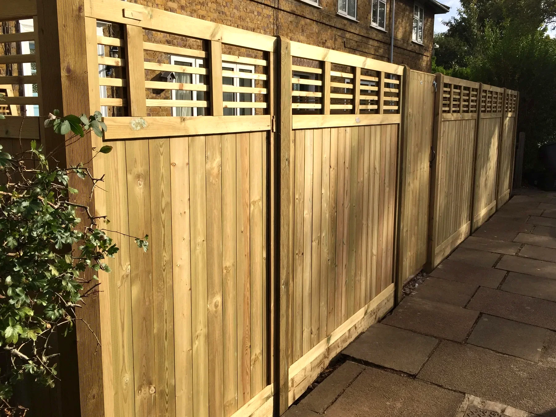 Vertical closeboard fence with lattice top in West London