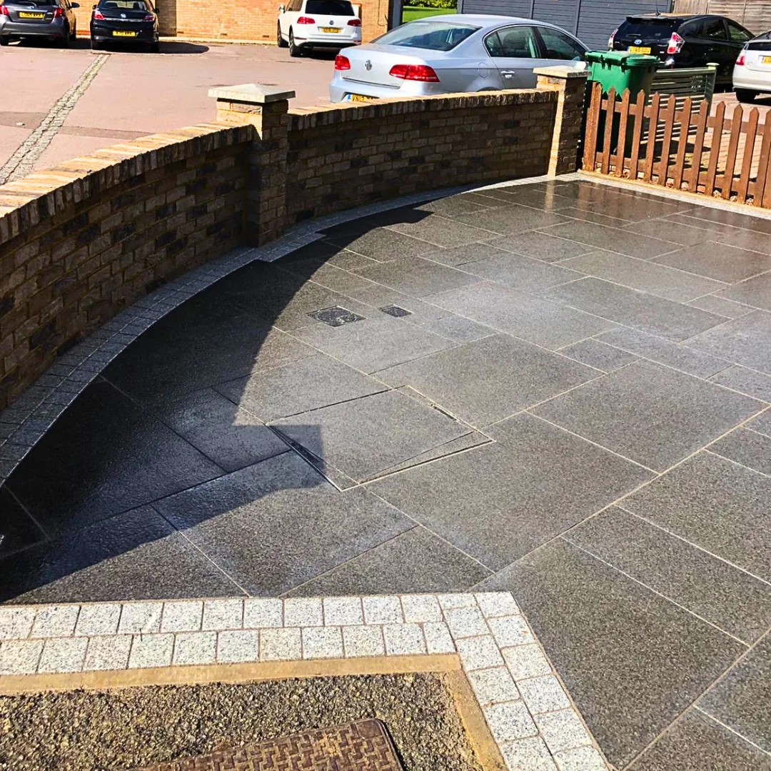 Granite driveway with black brick wall in West London