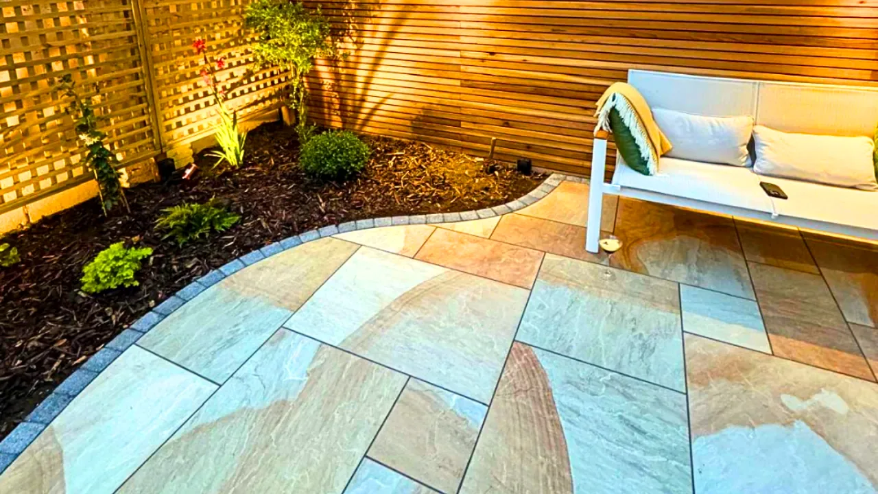 Modern Indian sandstone patio with cedar fence