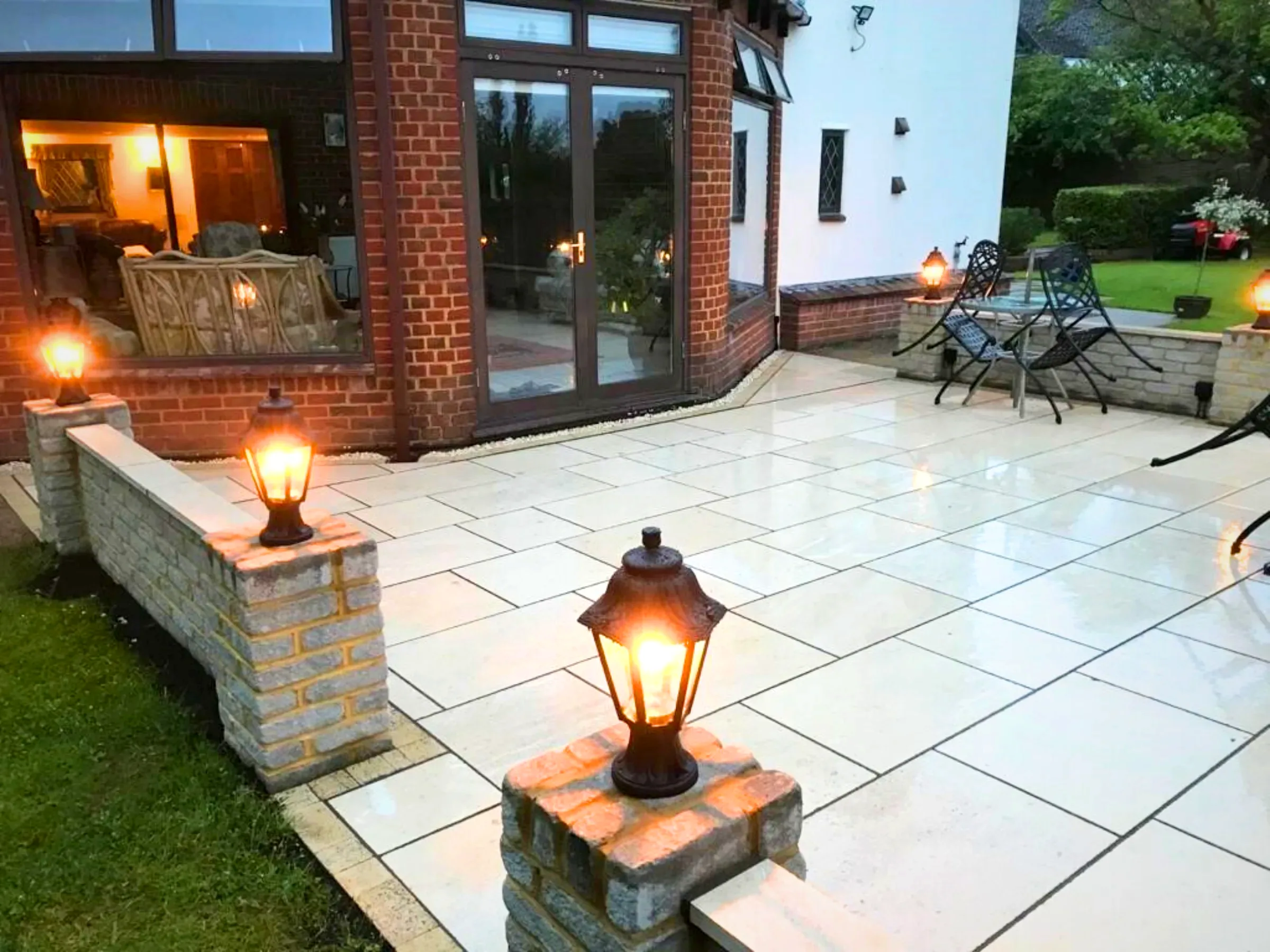 Cream sandstone patio with lanterns in Twickenham