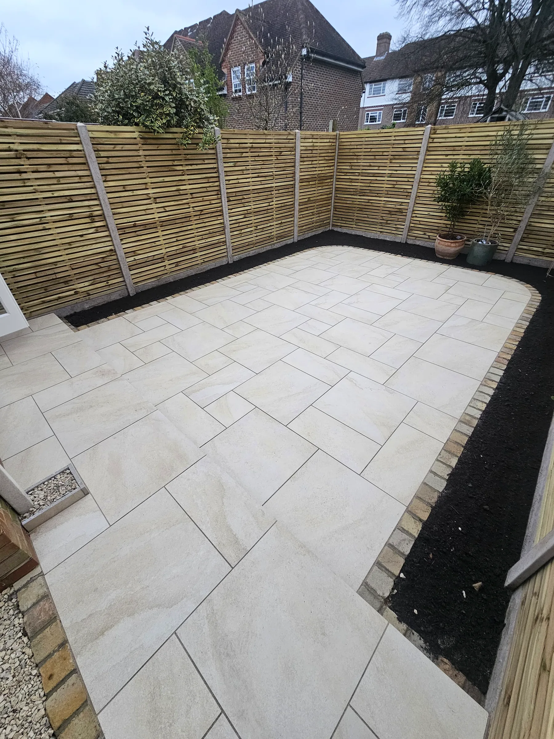 Porcelain patio with cedar fence in evening light