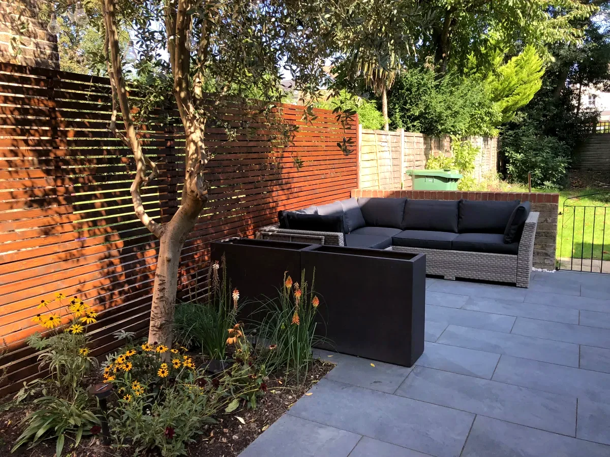 Shaded slate patio with corner sofa