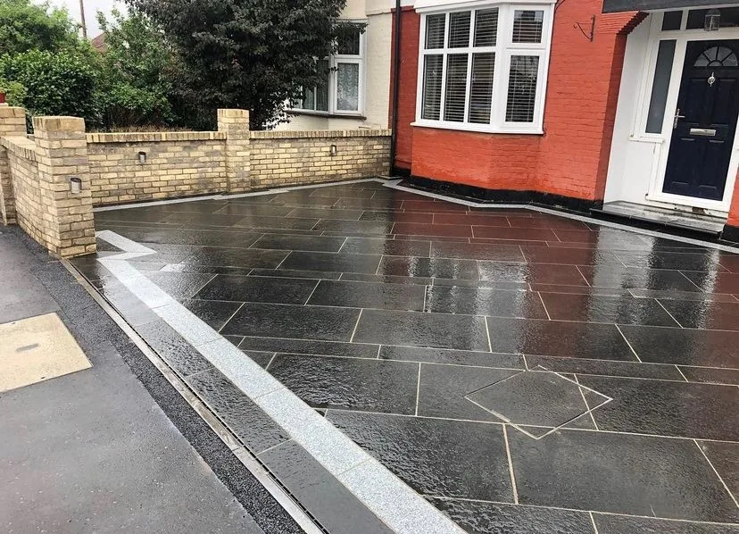 Slate black driveway with red brick walling in South West London