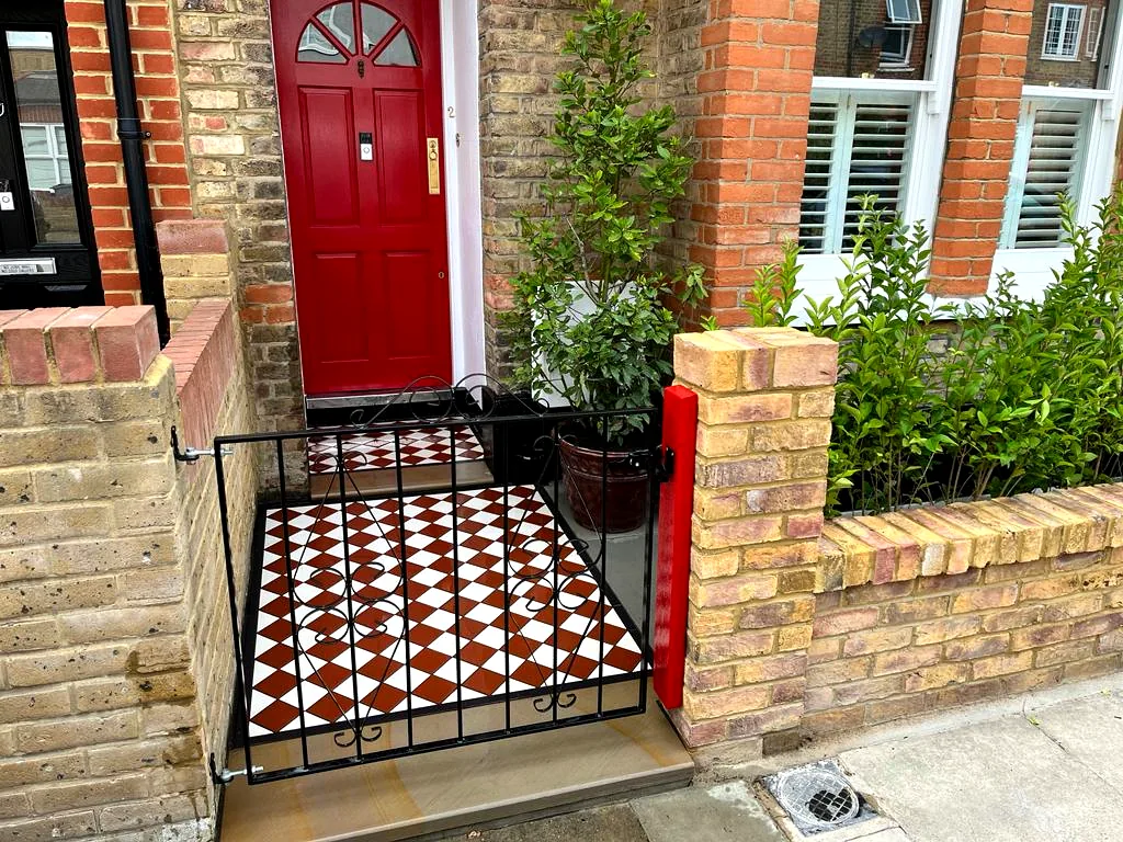 Brick pillars framing a Victorian tile entrance
