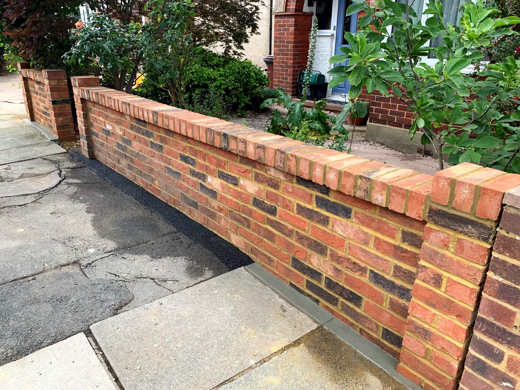 Red brick boundary wall in a front garden